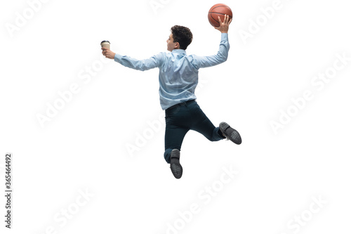 Leader. Man in office clothes playing basketball on white background like professional player, sportsman. Unusual look for businessman in motion, action with ball. Sport, healthy lifestyle, creativity