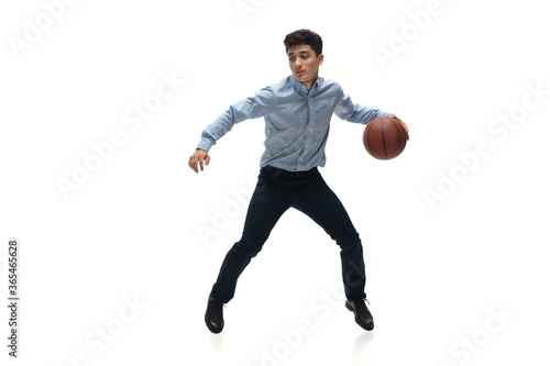 Leader. Man in office clothes playing basketball on white background like professional player, sportsman. Unusual look for businessman in motion, action with ball. Sport, healthy lifestyle, creativity © master1305