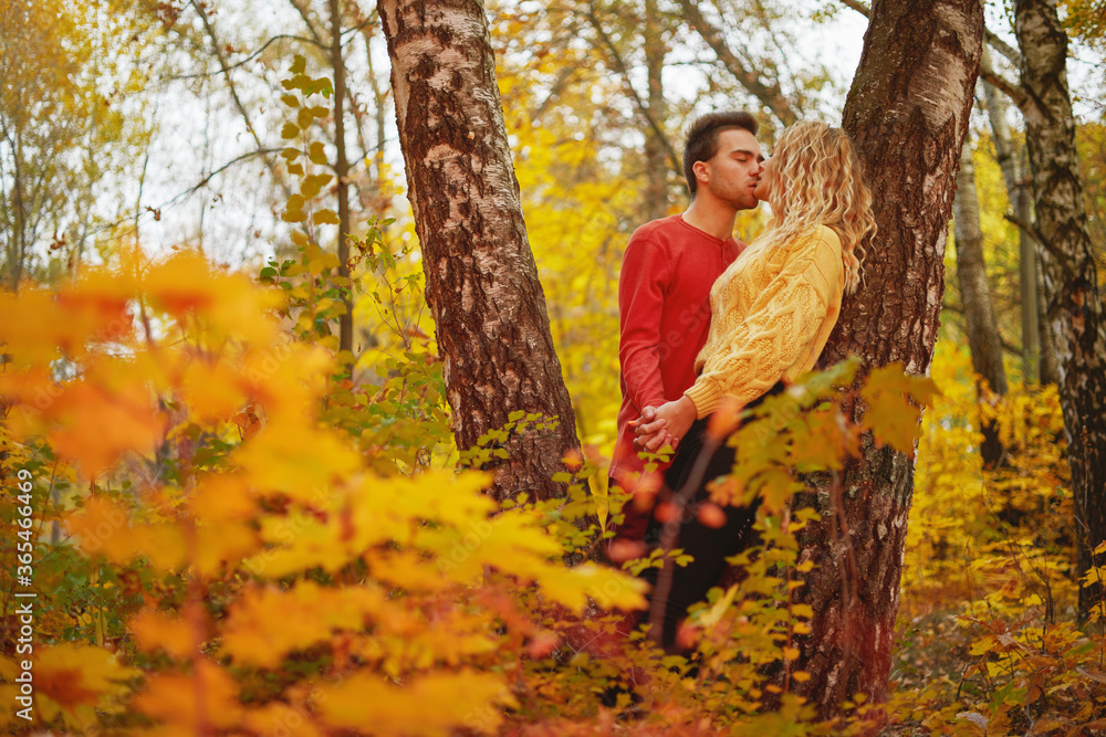 Happy young couple outdoors on a beautiful autumn day in the forest Happy young couple outdoors on a beautiful autumn day in the forest