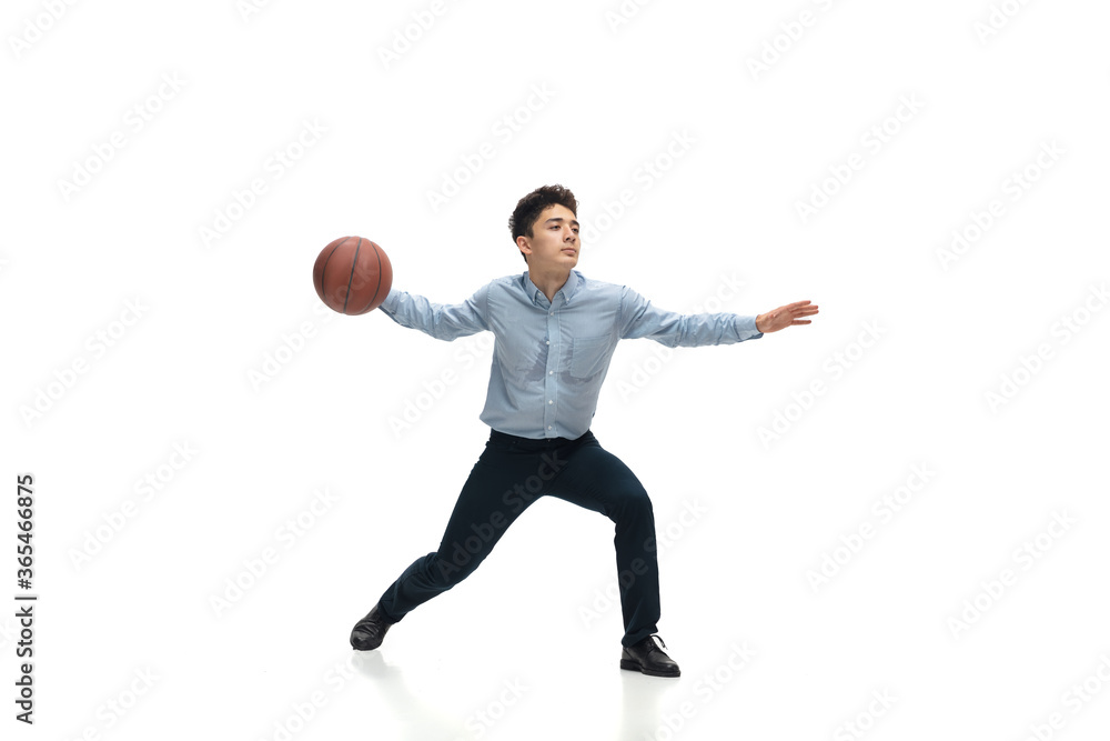 Achieves. Man in office clothes playing basketball on white background like professional player, sportsman. Unusual look for businessman in motion, action with ball. Sport, healthy lifestyle
