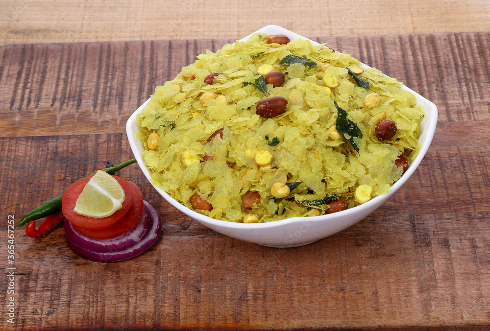 Indian Traditional Spicy And Sweet Mixture Namkeen Also Know as Chivda, Farsan, Namkin, Chiwada, or nylon chevdo on wooden Indian Traditional Spicy And Sweet Mixture Namkeen Also Know as Chivda, Farsan, Namkin, Chiwada, or nylon chevdo on wooden