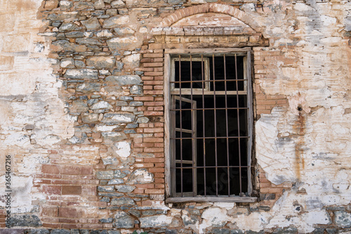 iron-barred windows historical brick wall