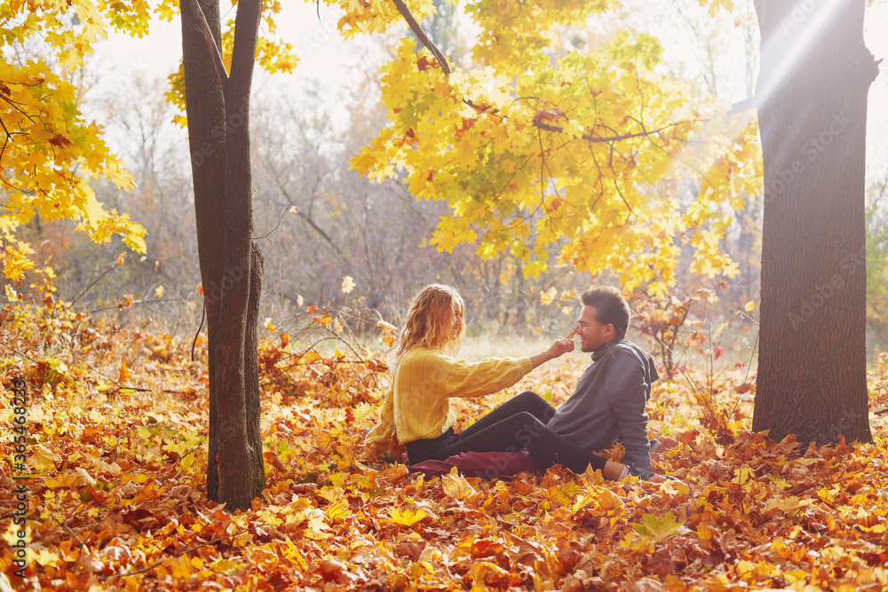 Happy young couple outdoors on a beautiful autumn day in the forest Happy young couple outdoors on a beautiful autumn day in the forest
