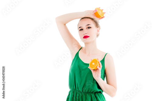 Emotional portrait of a girl with orange in hands on an isolated white background. The concept of a healthy diet, healthy lifestyle and vegetarianism