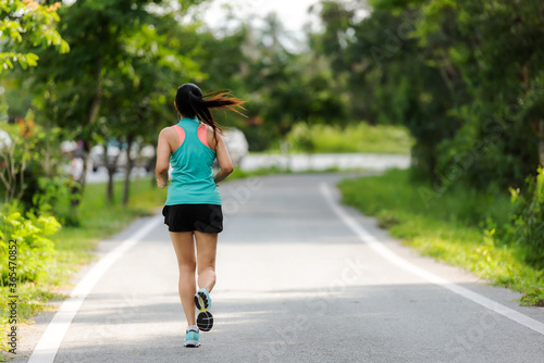 Healthy woman jogging run and workout on road outdoor. Asian runner people exercise gym with fitness session