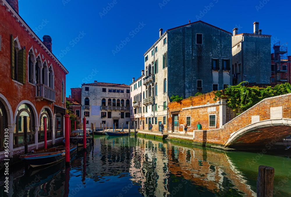 View of canals and cityscape with colorful buildings in Venice, Italy