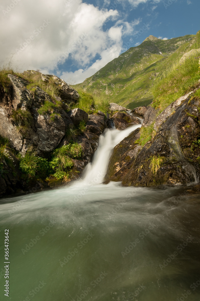 Waterfall in the mountain in a cloudy day Waterfall in the mountain in a cloudy day