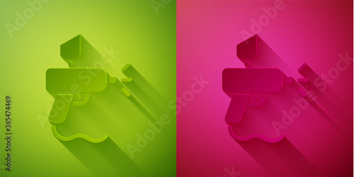 Paper cut Paint spray gun icon isolated on green and pink background. Paper art style. Vector Illustration.
