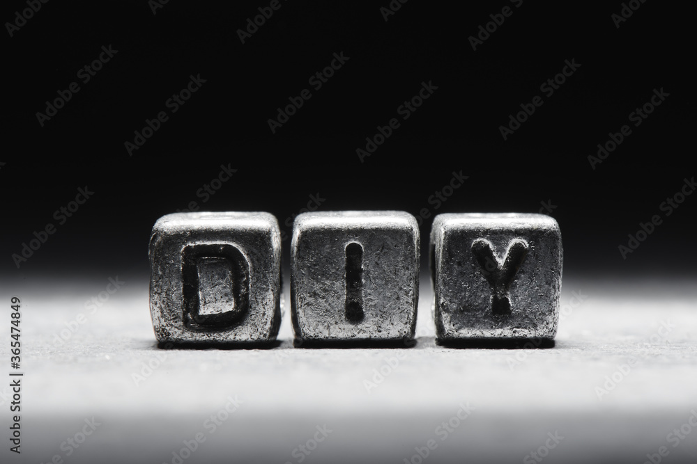 Inscription DIY on metal cubes in grunge style on a black темно серый background isolated Inscription DIY on metal cubes in grunge style on a black темно серый background isolated