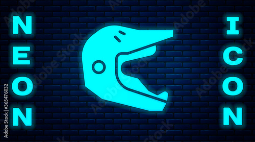 Glowing neon Motocross motorcycle helmet icon isolated on brick wall background. Vector Illustration.