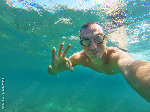 man swims underwater