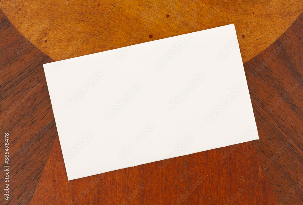 Blank white greeting card on light and dark wood mockup Blank white greeting card on light and dark wood mockup