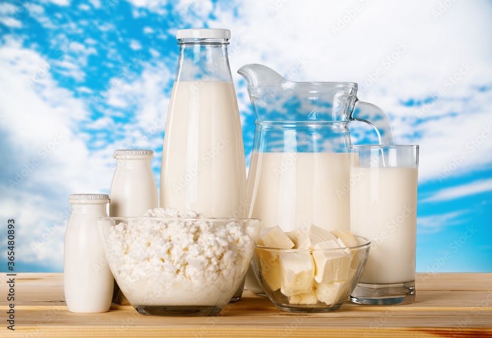 Glass of milk and dairy products on desk Glass of milk and dairy products on desk
