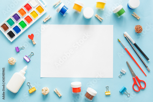 Colorful stationary school supplies on blue trending background