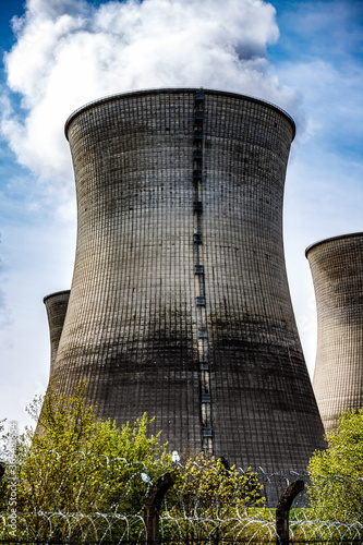 smoking cooling towers of a nuclear power plant with a enormous ladder