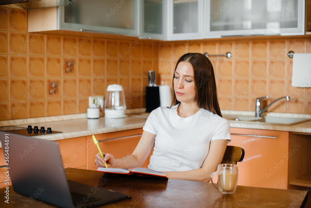 A young girl works at home on a remote site. Distance learning. Stay at home A young girl works at home on a remote site. Distance learning. Stay at home