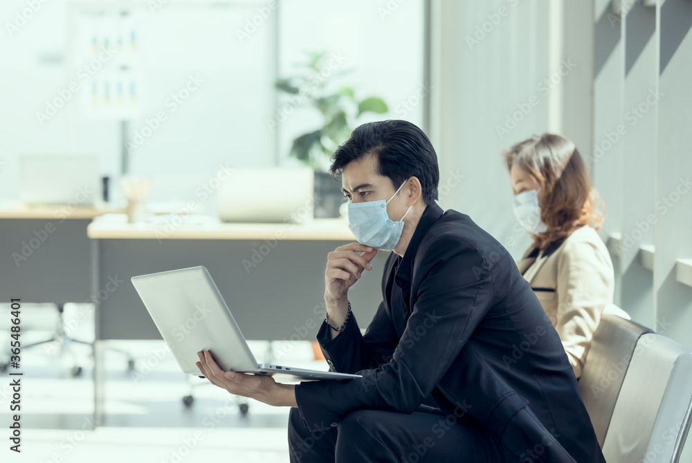 Business workers discussing business marketing and wearing medical face mask for social distancing in new normal situation for virus prevention. Business workers discussing business marketing and wearing medical face mask for social distancing in new normal situation for virus prevention.
