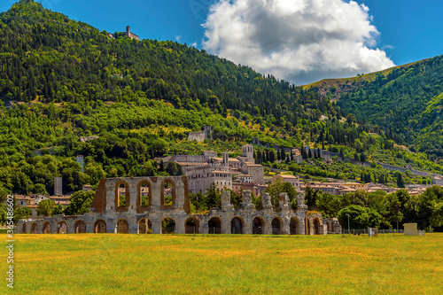 Wallpaper Mural The Roman arches of the ampitheater stand proud at the foot of Mount Ingino in the city of Gubbio, Italy in summer Torontodigital.ca
