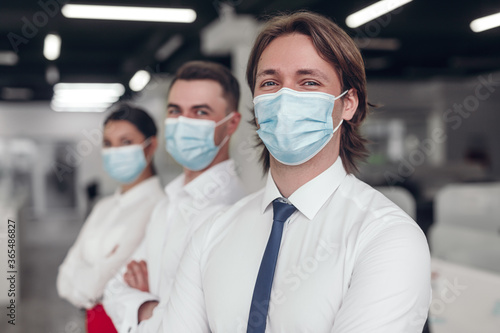 Businessman in medical mask as part of team