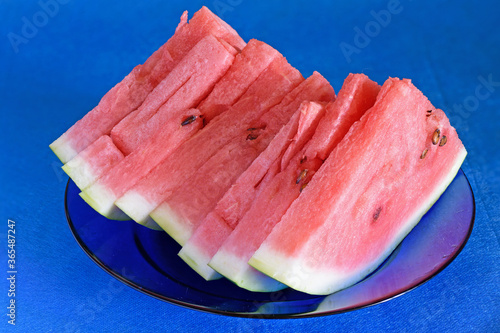 Still-life. Slices of ripe red watermelon on a glass plate close-up.