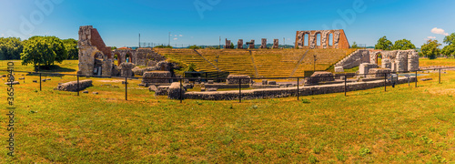 A panorama view across the ruins of the Roman ampitheater in the cathedral city of Gubbio, Italy in summer