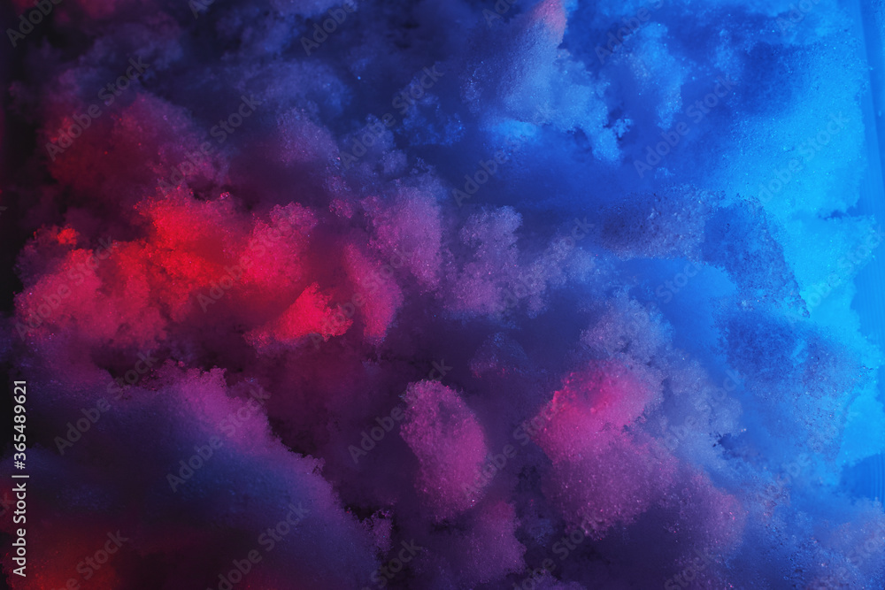 Closeup of snow at night in neon colored light. Closeup of snow at night in neon colored light.