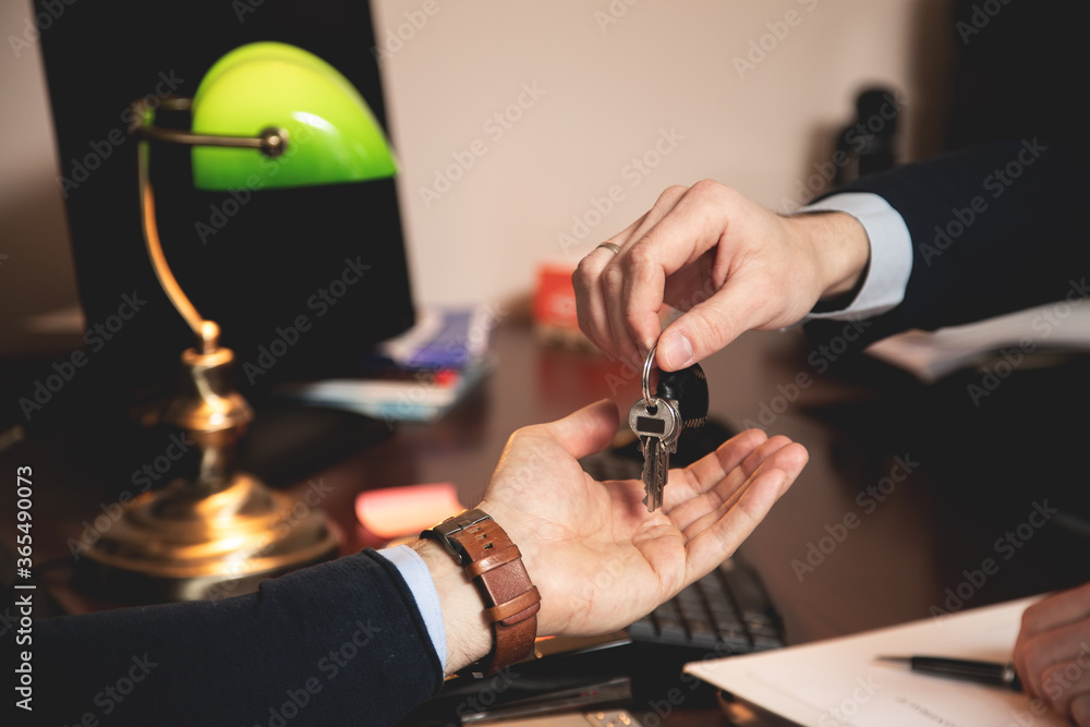 The lawyer gives the keys to the apartment to his client, after the contract has been signed The lawyer gives the keys to the apartment to his client, after the contract has been signed