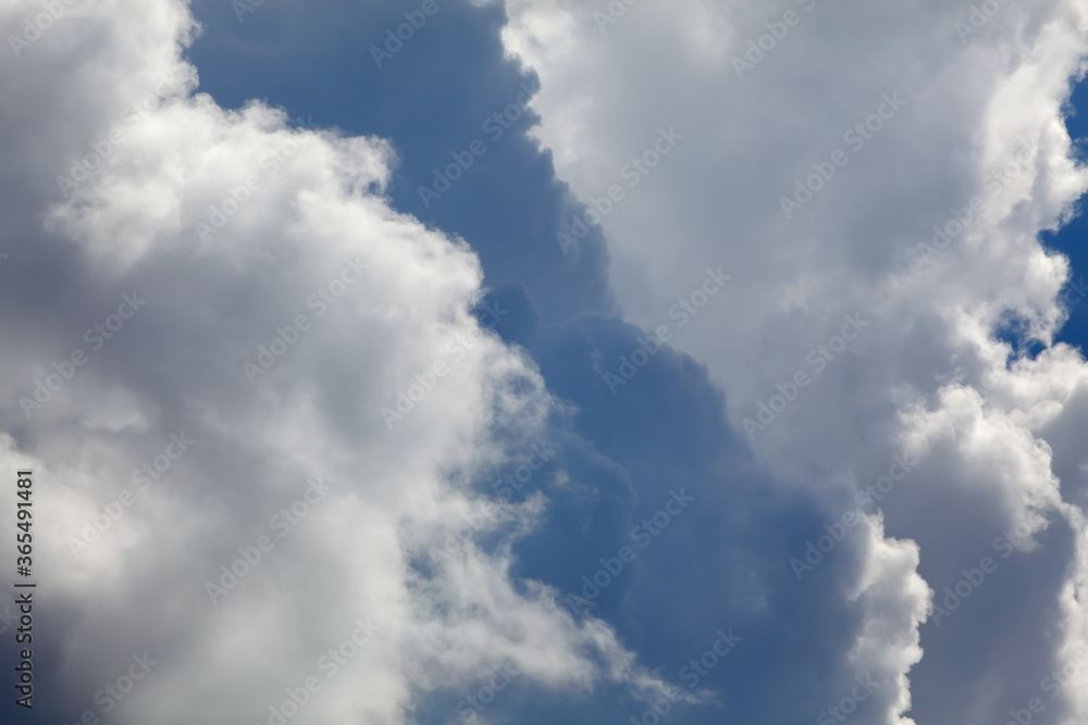 Telephoto closeup photo of dramatic clouds at blue sky Telephoto closeup photo of dramatic clouds at blue sky