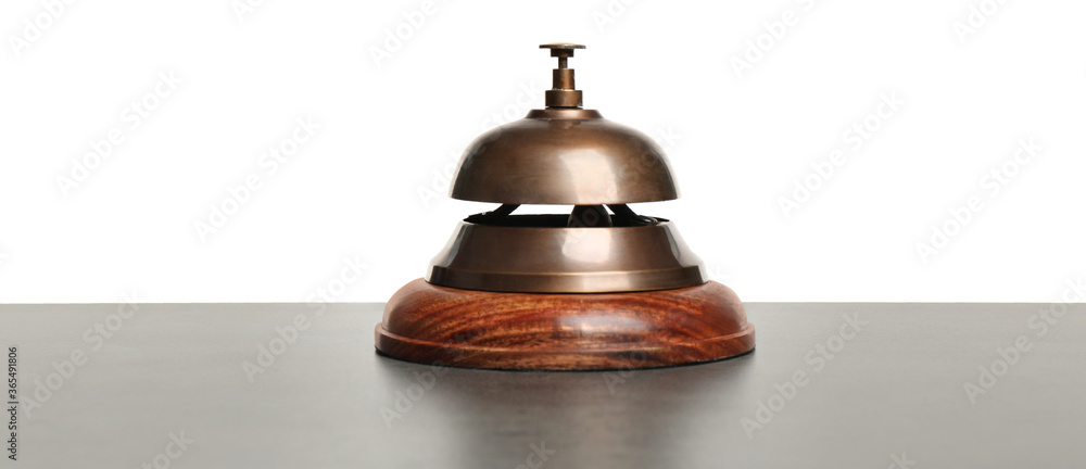 Hotel service bell on grey stone table against white background Hotel service bell on grey stone table against white background
