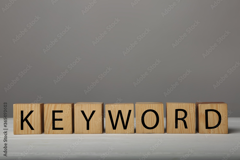 Word KEYWORD made of wooden cubes on grey background Word KEYWORD made of wooden cubes on grey background
