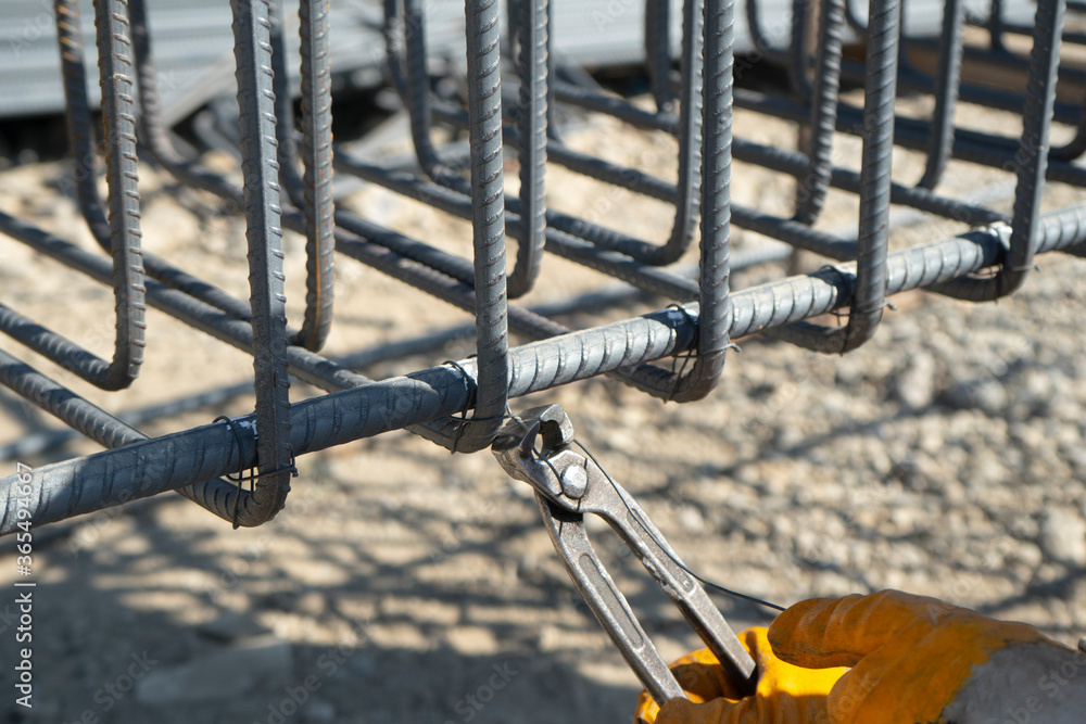 construction worker working in iron bending with pincers. Only hands construction worker working in iron bending with pincers. Only hands