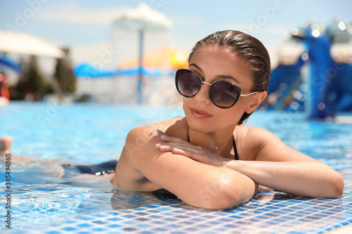 Young woman in outdoor swimming pool. Summer vacation © New Africa