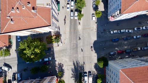 Aerial view of the roundabout at the city center. City roads, buildings and vehicles can be seen.  photo