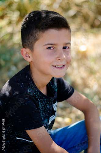 handsome boy model in black shirt, natural background
