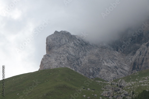 A close up of a rock mountain with clouds