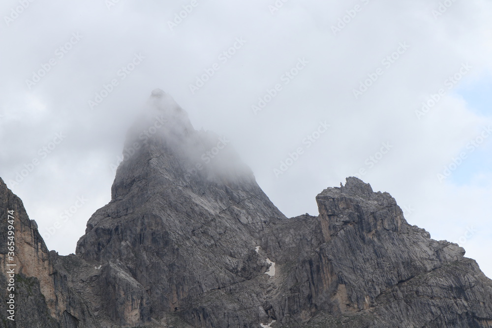 A close up of a rock mountain with clouds