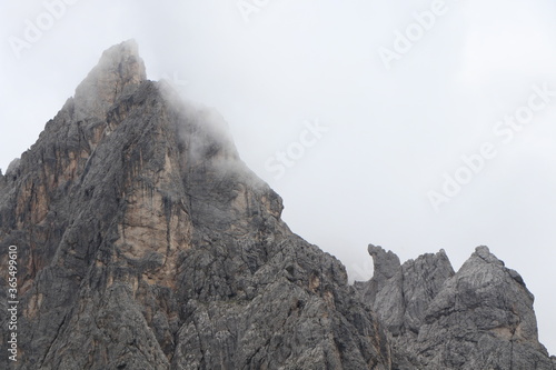 A close up of a rock mountain with clouds