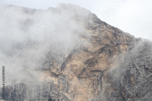 A close up of a rock mountain with clouds
