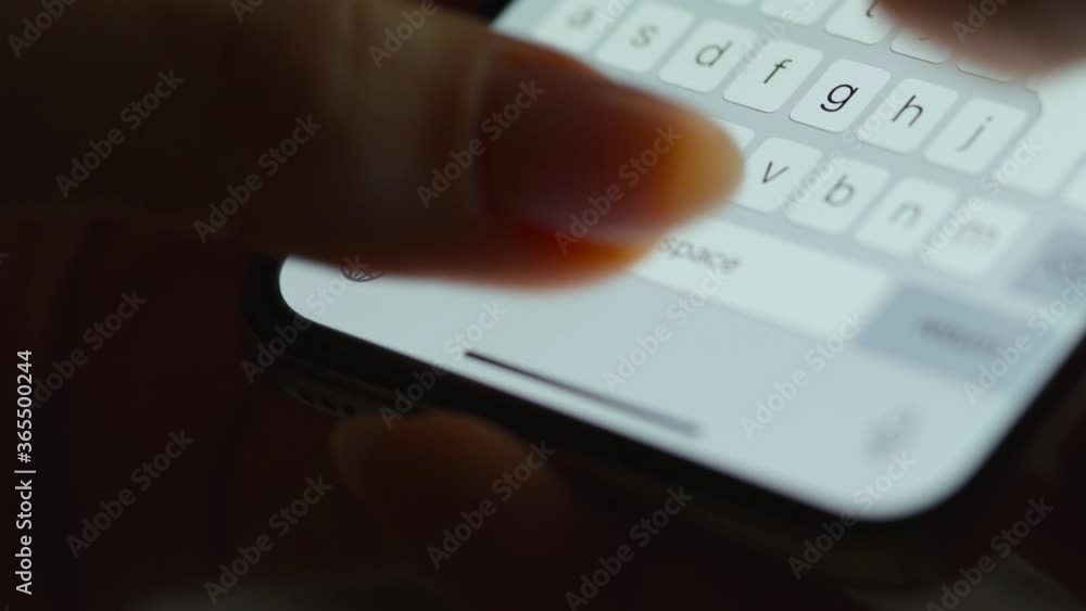 Hands typing text on smartphone close-up. Using smartphone close up at night. Hands typing text on smartphone close-up. Using smartphone close up at night.