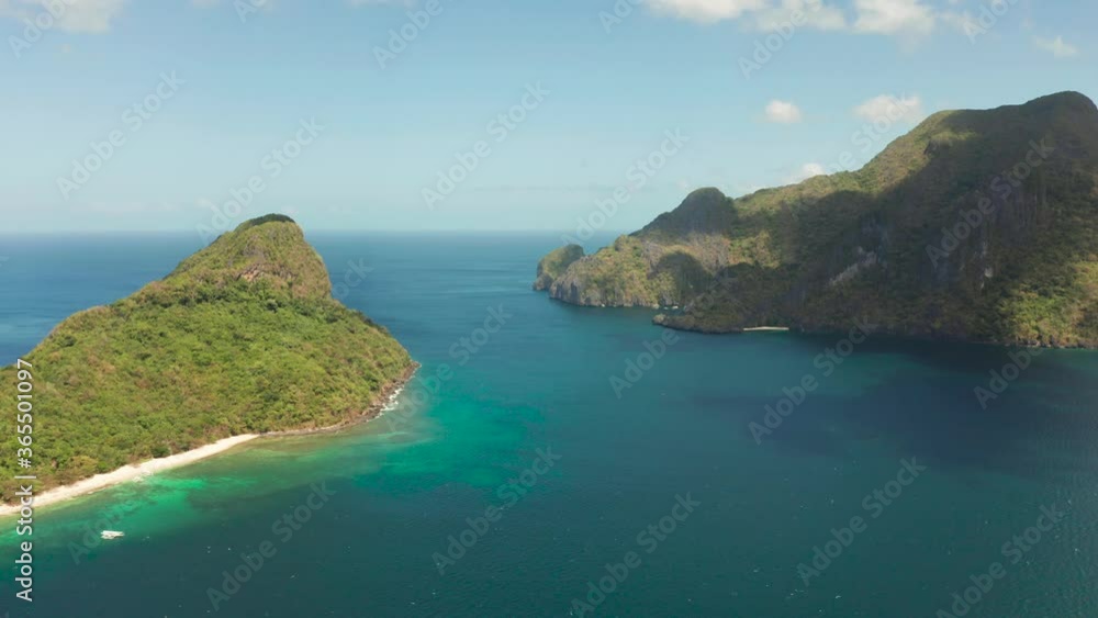 aerial view tropical beach on island with palm trees, blue lagoon and azure clear water. Helicopter Island in El Nido, Palawan Philippines. Tropical landscape with blue lagoon, coral reef aerial view tropical beach on island with palm trees, blue lagoon and azure clear water. Helicopter Island in El Nido, Palawan Philippines. Tropical landscape with blue lagoon, coral reef