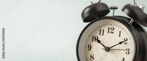 Retro style alarm clock on blue background