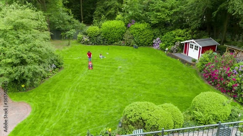Woman Mowing Backyard Lawn in Time Lapse