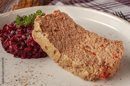 Fresh chicken terrine with beetroot confiture and parsley on a platter photo