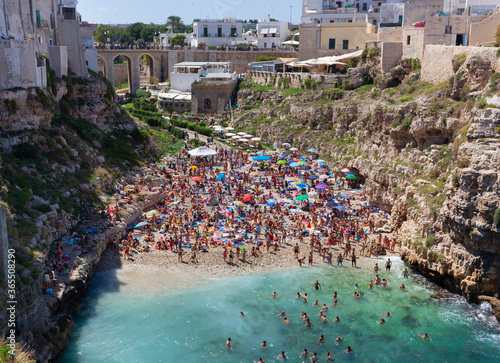 People relax and swimming on lovely beach Lama Monachile in Polignano a Mare photo