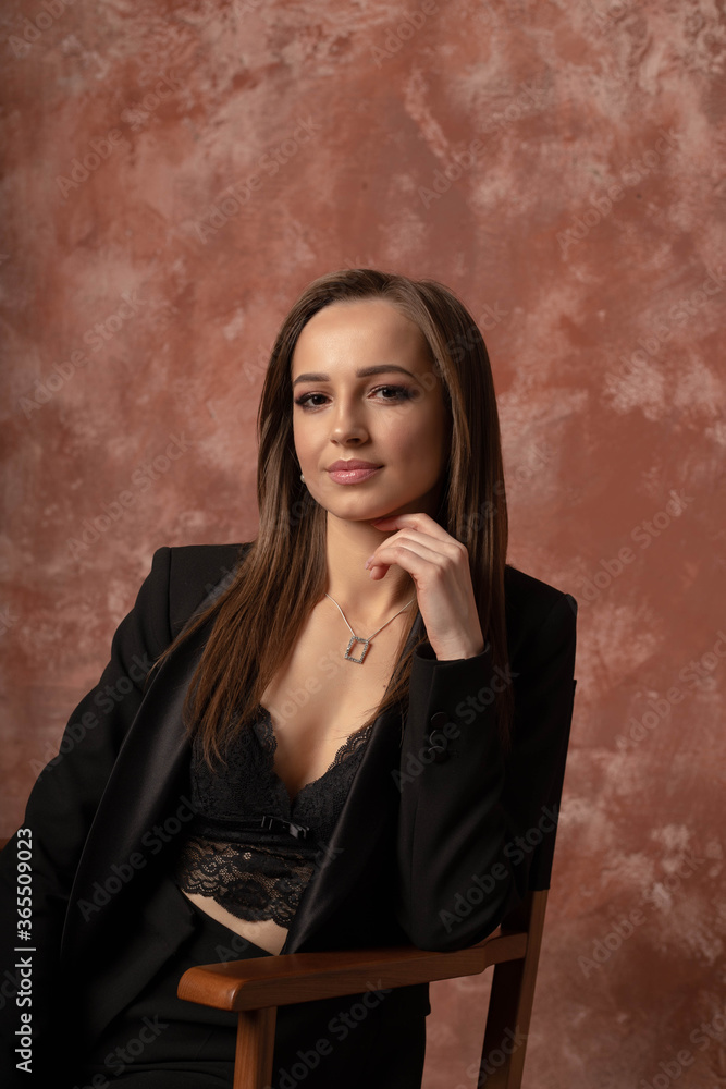 beautiful brunette girl in a black suit, business lady beautiful brunette girl in a black suit, business lady