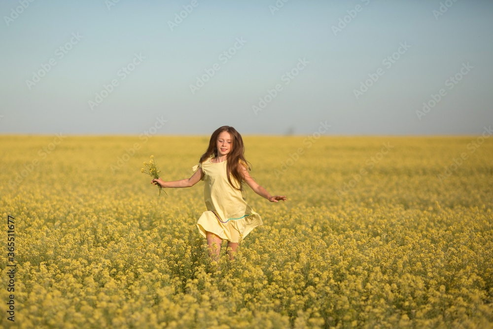portrait of a teenage girl in a yellow dress running across the field in summer portrait of a teenage girl in a yellow dress running across the field in summer