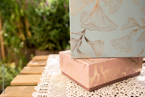 Blue and a pink box with ornaments on a table photo