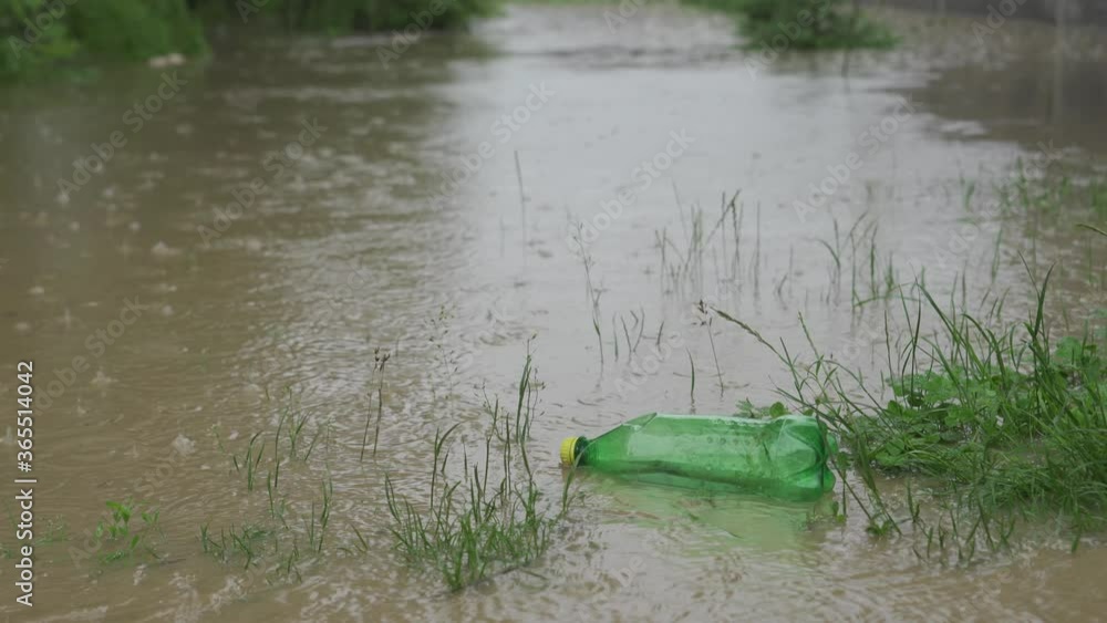 An empty plastic bottle of carbonated drinks floats on the water during