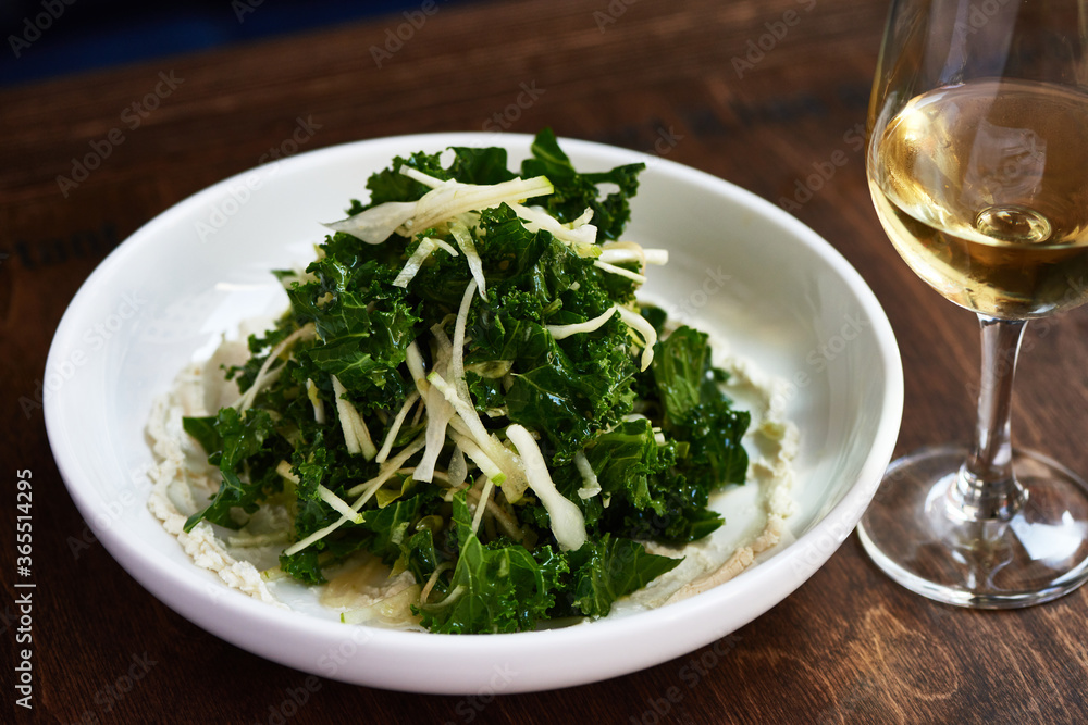 Kale Salad with Green Apple on Wooden Table Kale Salad with Green Apple on Wooden Table