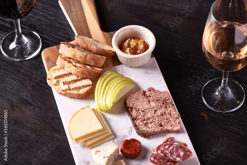 Charcuterie Meat and Cheese Plate on Marble and Wood